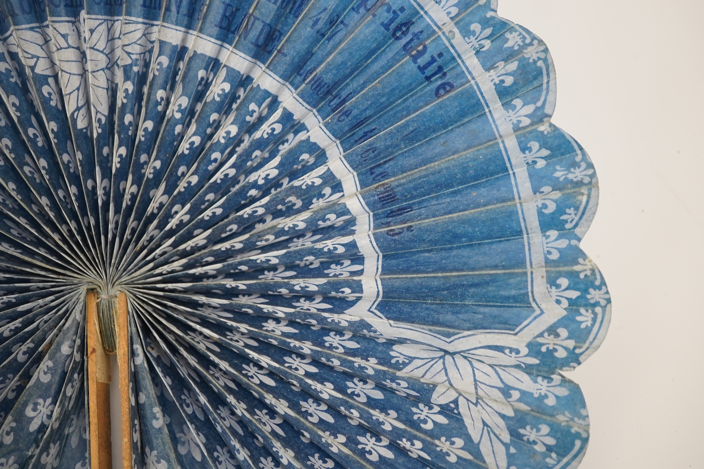 Three novelty fans with a mixed Brussels lace fan and black lace fan, a small language of love in flowers fan, a paper windmill advertising French Café fan, a carved cream Bakelite fan, a black and gilt, lace and sequin